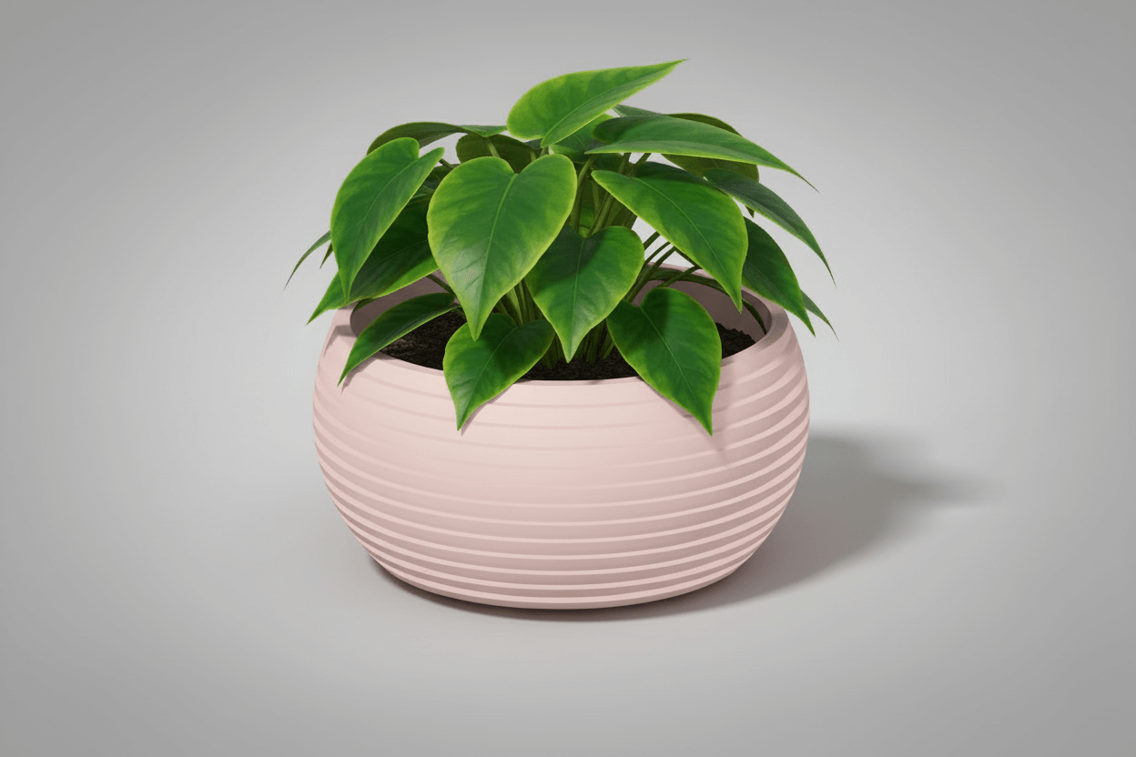 Modern Curved Decorative Planter with lush green leaves in a contemporary pink design.