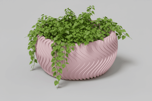 curved planter for small plants with trailing greenery against a light background